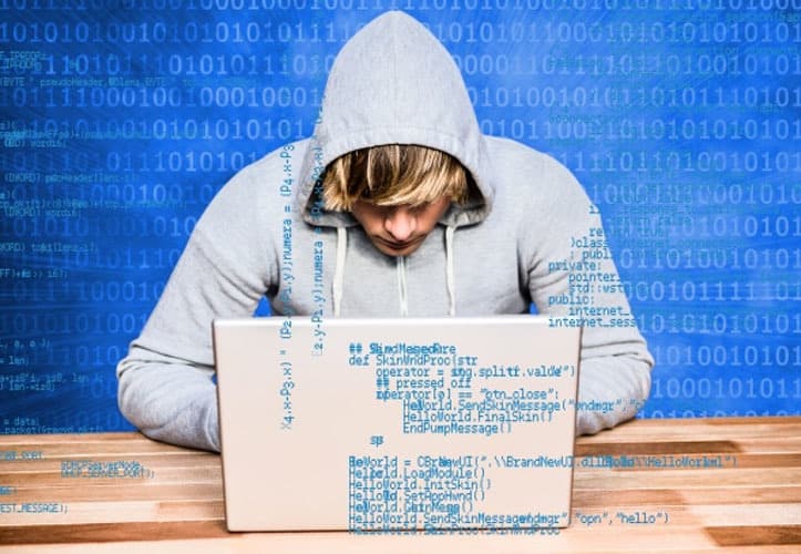 Hacker using a computer to spy on businesses